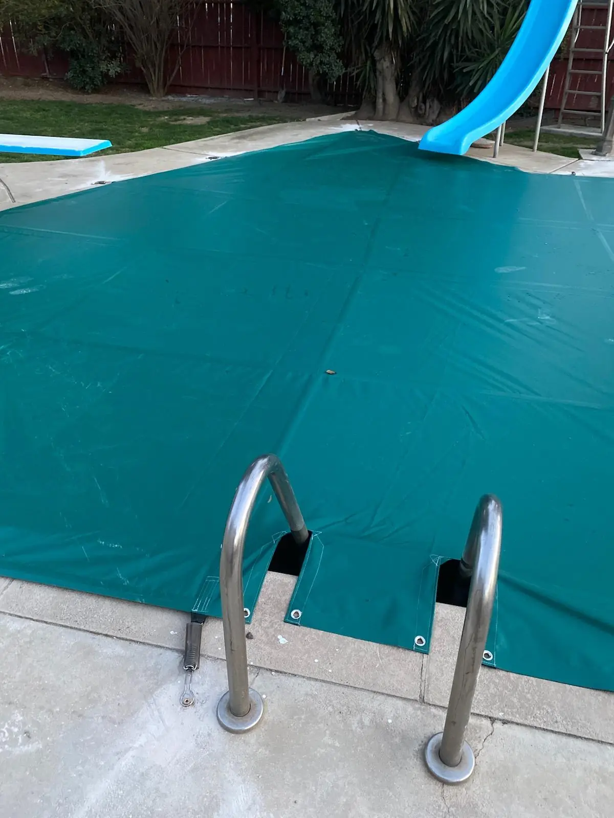 Reinforced custom pool cover openings fitted around a pool ladder