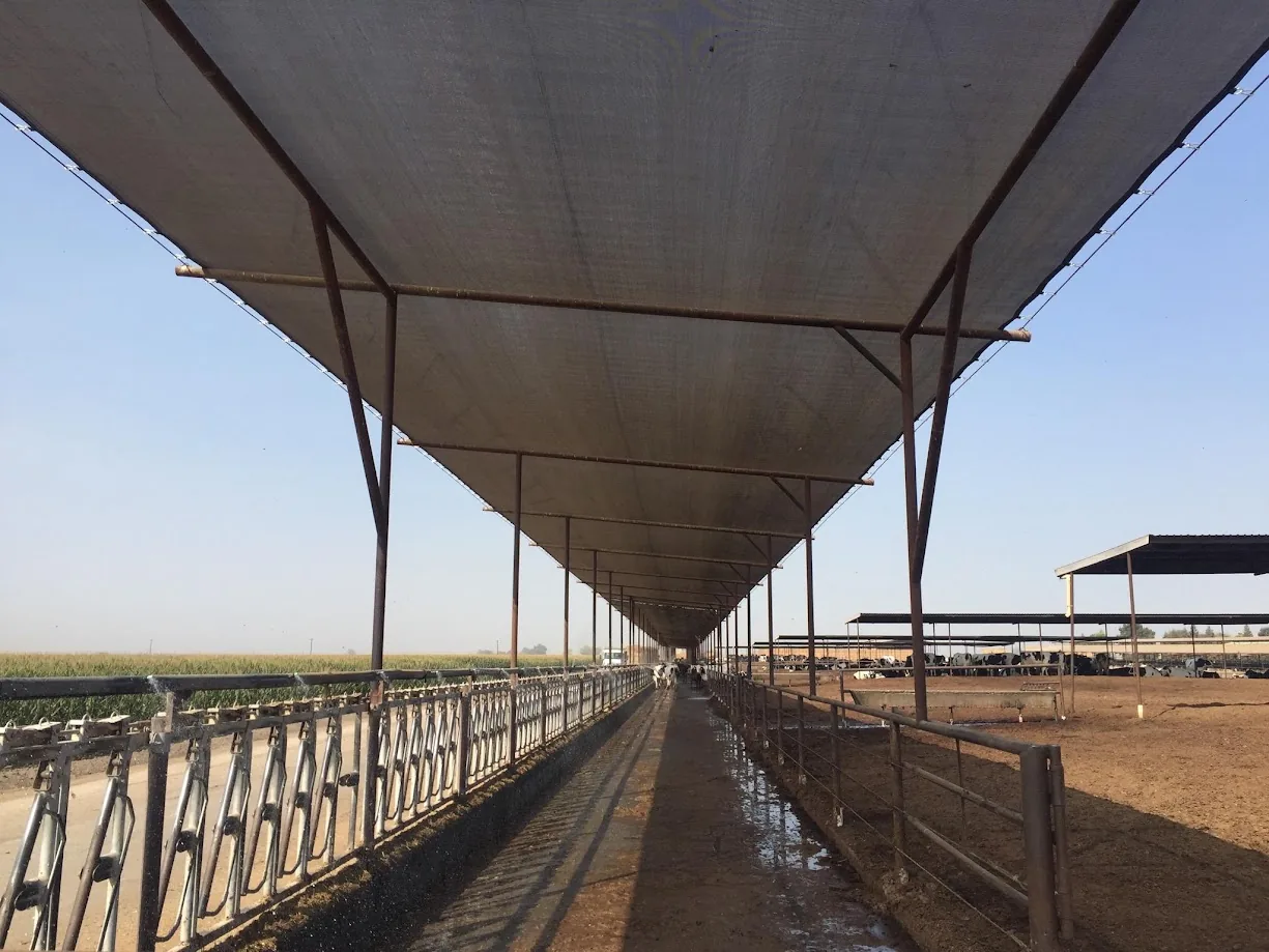 Commercial shade mesh installed over an outdoor work area