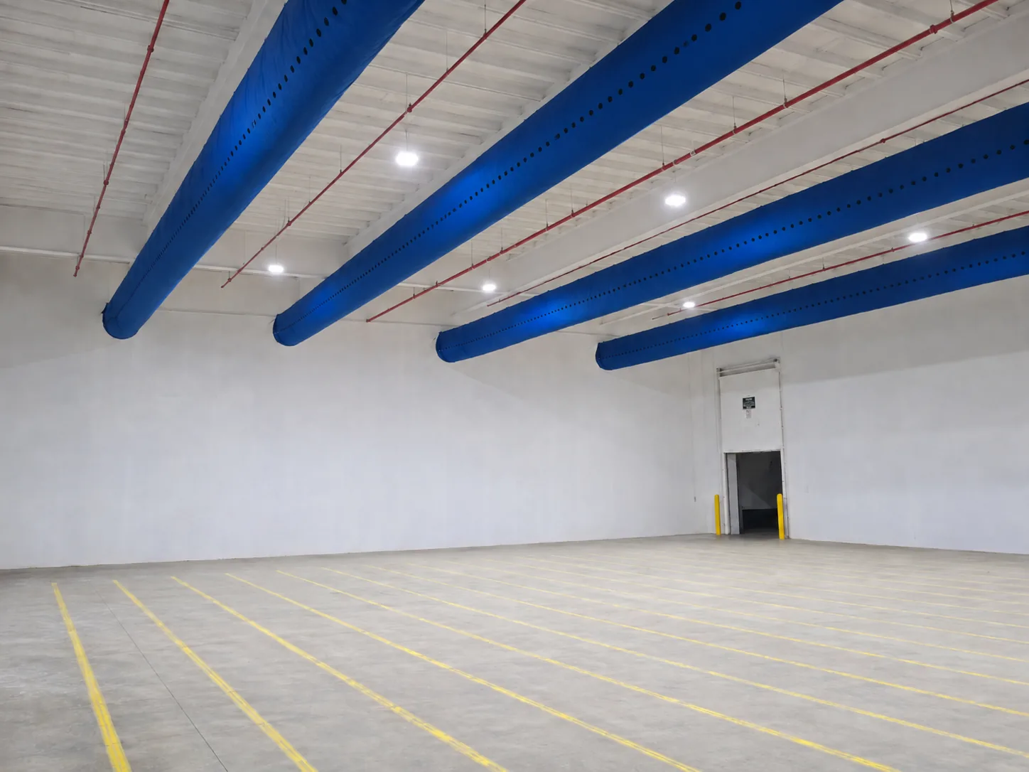 Overhead duct socks inside an industrial warehouse